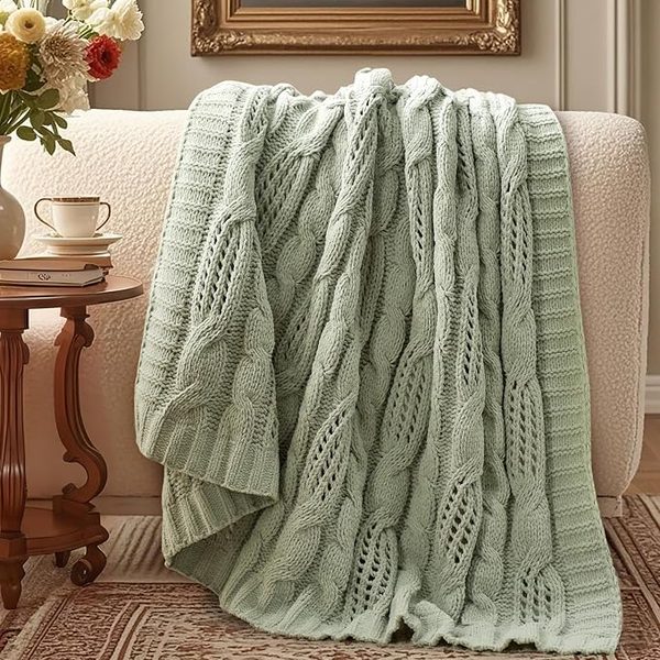 Sage cable-knit throw – camel leather sofa living room ideas